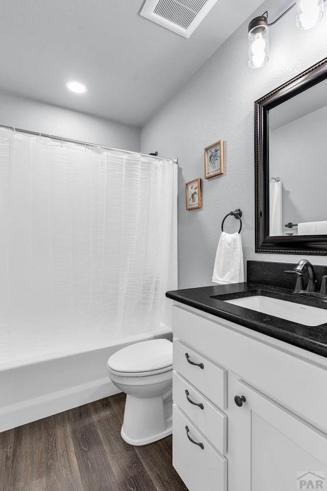 1207 N Jon Ln, Pueblo West, CO 81007 - full bathroom featuring vanity, wood finished floors, shower / tub combo, and recessed lighting