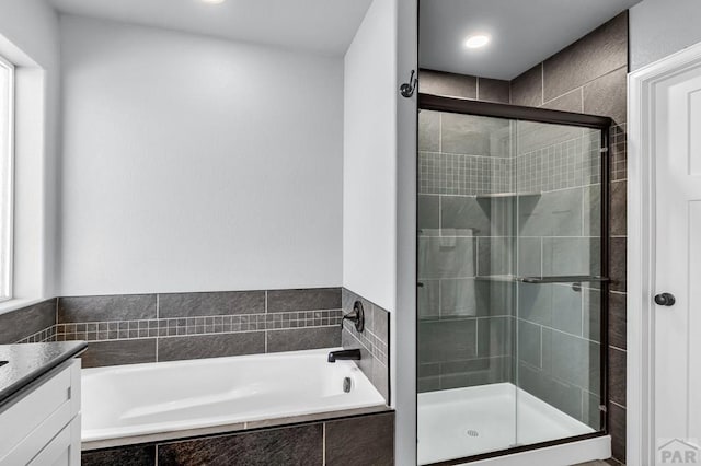 1207 N Jon Ln, Pueblo West, CO 81007 - full bathroom with a garden tub, a stall shower, vanity, and recessed lighting