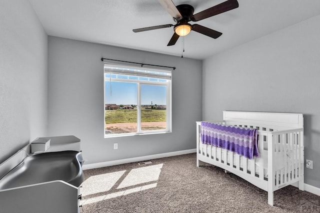 1207 N Jon Ln, Pueblo West, CO 81007 - bedroom with carpet flooring, a crib, and ceiling fan