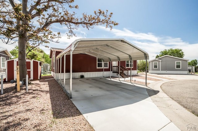 999 Fortino Blvd Unit 237, Pueblo, CO 81008 - view of front of house with a storage unit, concrete driveway, an outbuilding, and a detached carport