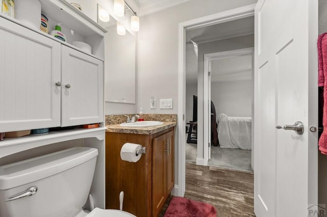 999 Fortino Blvd Unit 237, Pueblo, CO 81008 - half bath featuring ornamental molding, wood finished floors, vanity, and toilet
