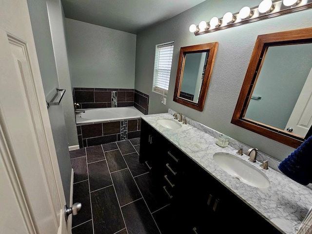 bathroom featuring a garden tub, tile patterned floors, a sink, and double vanity