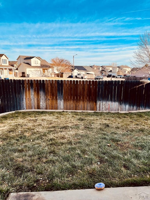 view of yard with fence and a residential view