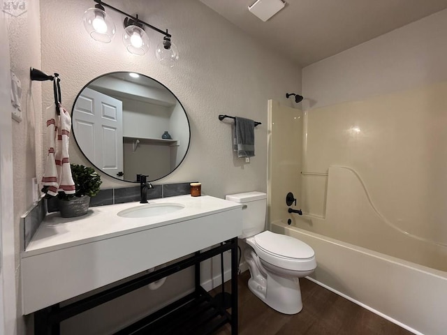 326 W Golden Eagle Way Unit 328, Pueblo West, CO 81007 - bathroom with toilet, wood finished floors, vanity, and  shower combination