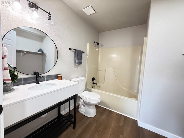 326 W Golden Eagle Way Unit 328, Pueblo West, CO 81007 - full bathroom featuring wood finished floors, toilet, washtub / shower combination, and vanity