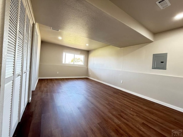 326 W Golden Eagle Way Unit 328, Pueblo West, CO 81007 - unfurnished bedroom with electric panel, baseboards, dark wood finished floors, recessed lighting, and a textured ceiling