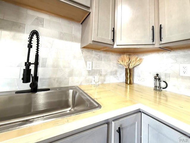 326 W Golden Eagle Way Unit 328, Pueblo West, CO 81007 - kitchen view of a sink, light countertops, and backsplash