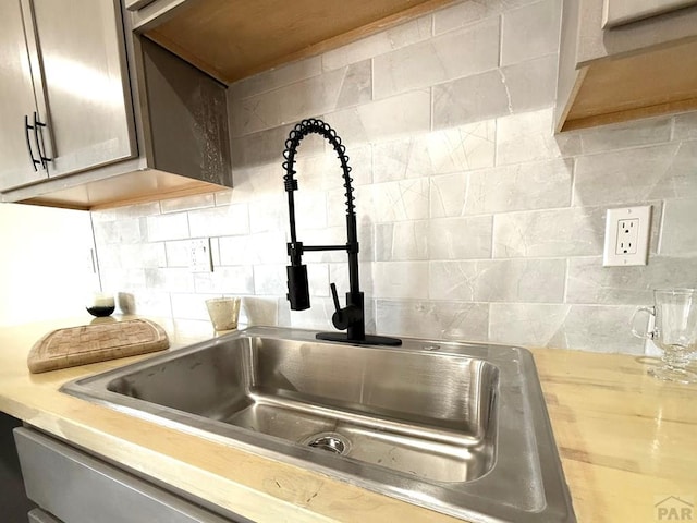 326 W Golden Eagle Way Unit 328, Pueblo West, CO 81007 - kitchen view of a sink, tasteful backsplash, and light countertops