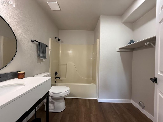326 W Golden Eagle Way Unit 328, Pueblo West, CO 81007 - full bath featuring wood finished floors, toilet, bathing tub / shower combination, vanity, and baseboards