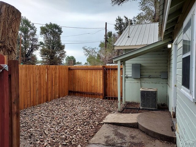 view of yard featuring a fenced backyard and central air condition unit