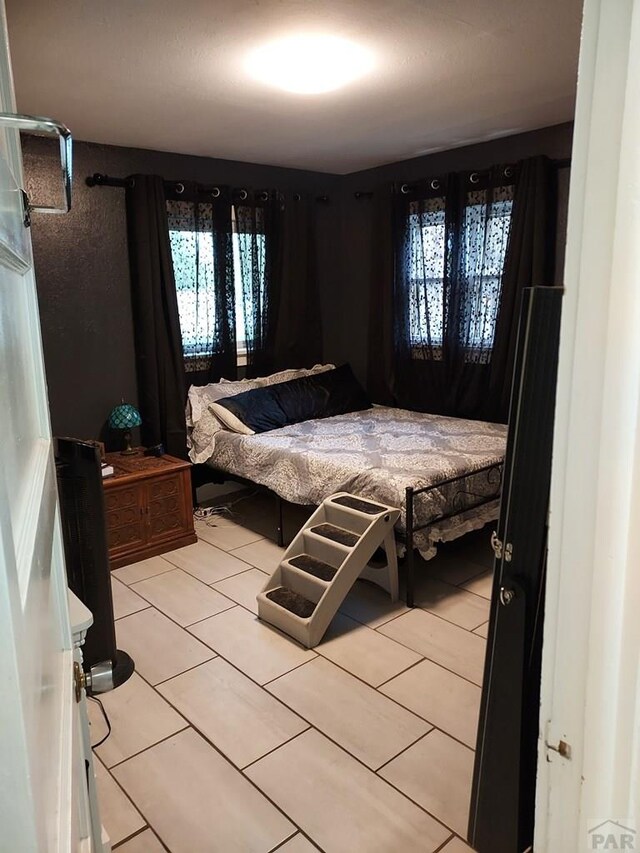 bedroom featuring light tile patterned flooring