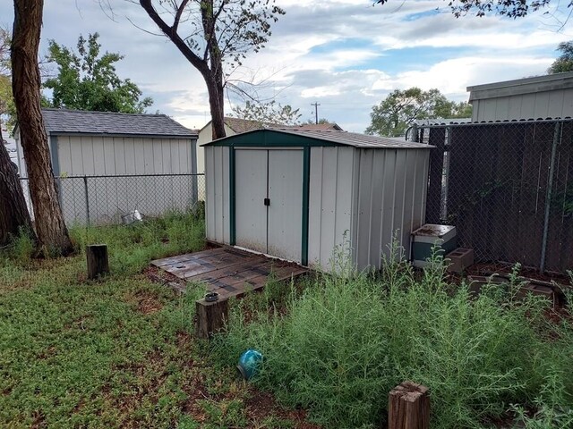 view of shed featuring fence