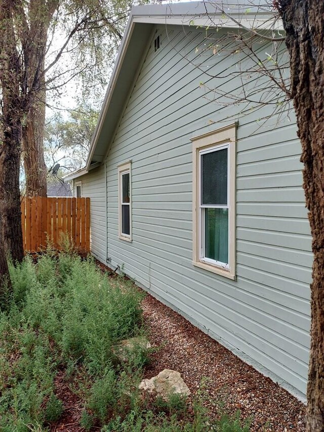 view of side of property with fence