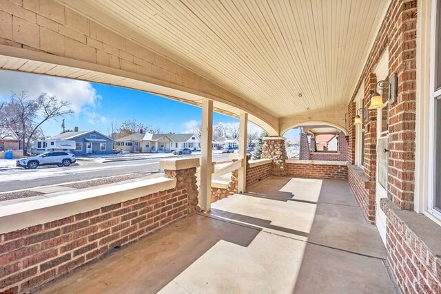 view of patio / terrace with a residential view and a porch