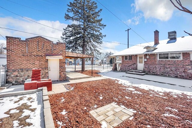 yard layered in snow with fence