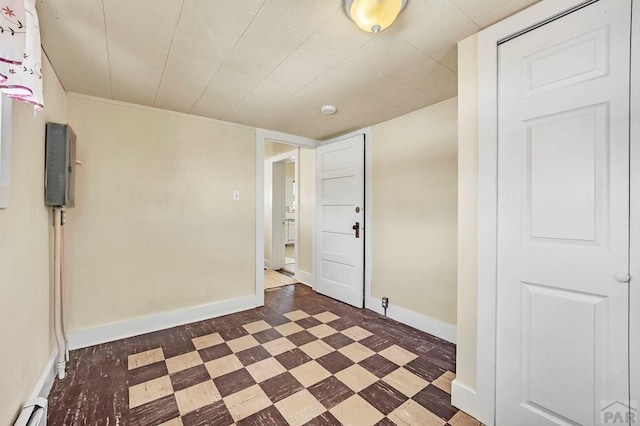 unfurnished room featuring dark floors, a baseboard radiator, and baseboards