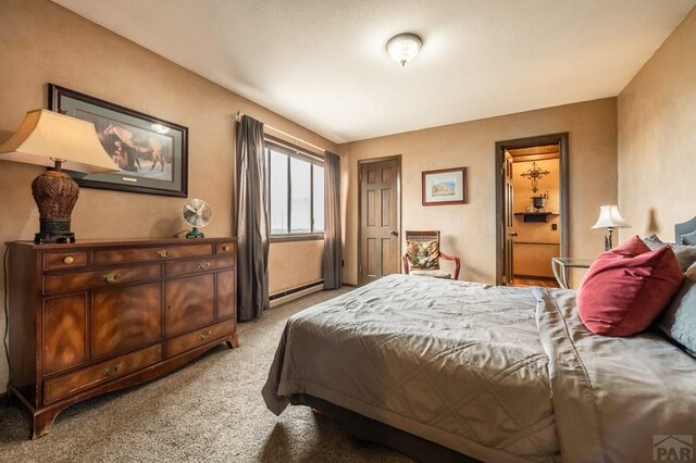 bedroom with a baseboard radiator and light colored carpet