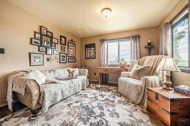 sitting room featuring a healthy amount of sunlight and baseboards