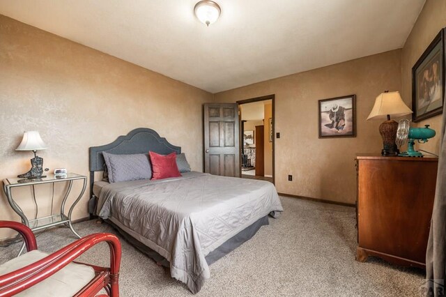 bedroom featuring baseboards and carpet flooring