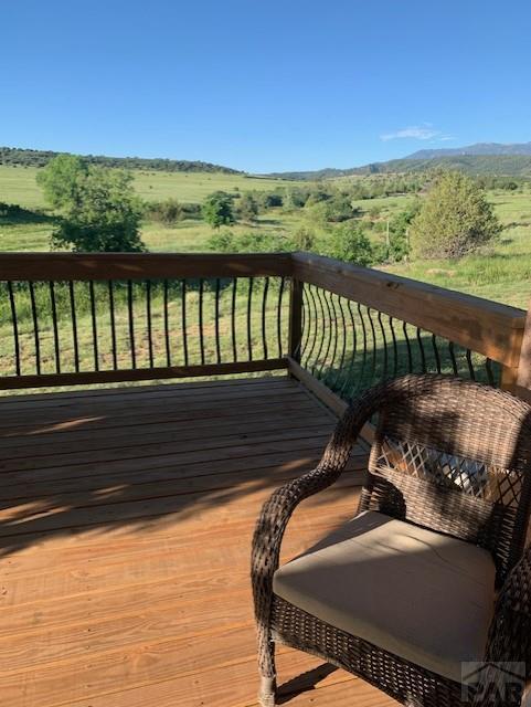 wooden deck featuring a rural view