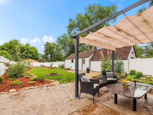 view of patio featuring an outbuilding, a fenced backyard, and a pergola