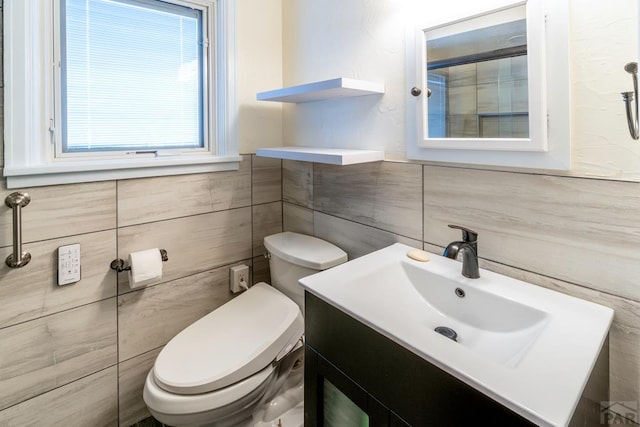 half bathroom with toilet, tile walls, and vanity