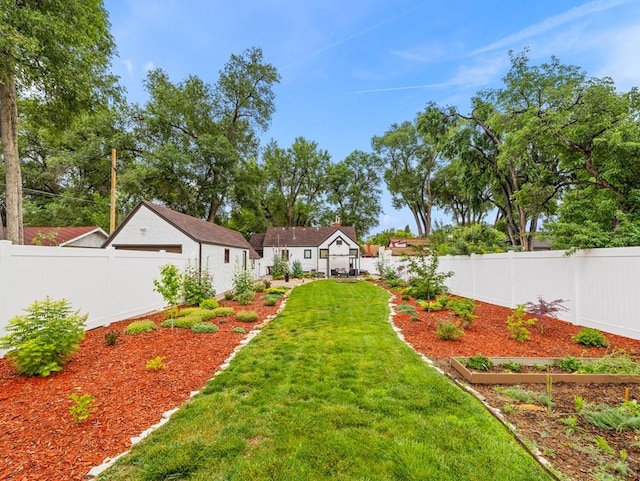 view of yard with a fenced backyard and a vegetable garden