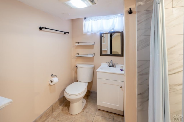 bathroom with toilet, tile patterned flooring, baseboards, and vanity