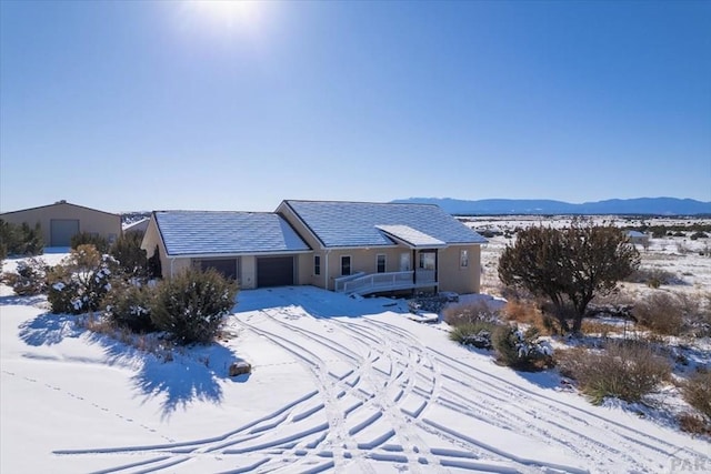 single story home with a garage and a mountain view