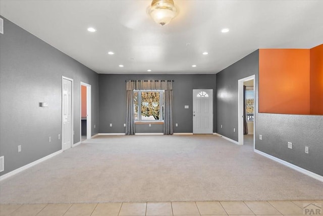 unfurnished room with recessed lighting, light colored carpet, and baseboards