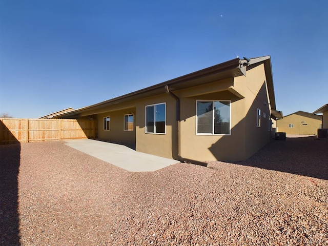 151 S Stardust Cir, Pueblo West, CO 81007 - back of property featuring a patio, stucco siding, fence, and central AC