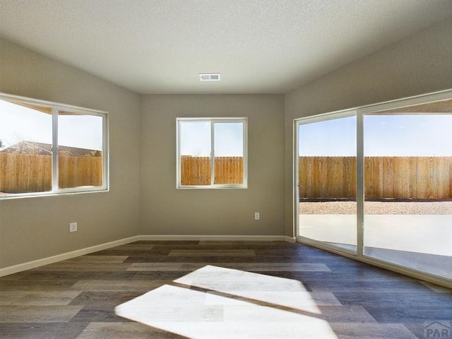 151 S Stardust Cir, Pueblo West, CO 81007 - unfurnished room featuring visible vents, plenty of natural light, and wood finished floors