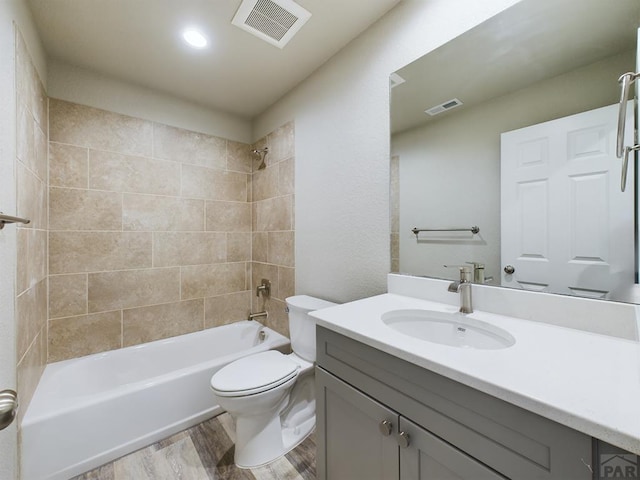 151 S Stardust Cir, Pueblo West, CO 81007 - bathroom featuring visible vents, bathtub / shower combination, toilet, and wood finished floors