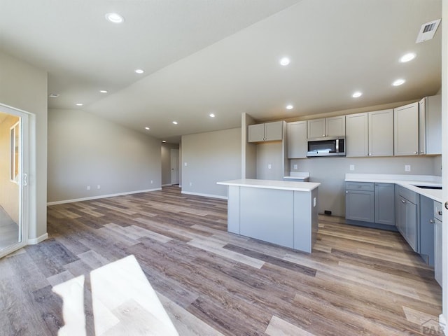 151 S Stardust Cir, Pueblo West, CO 81007 - kitchen featuring visible vents, stainless steel microwave, recessed lighting, and vaulted ceiling