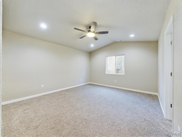151 S Stardust Cir, Pueblo West, CO 81007 - carpeted empty room with ceiling fan, a textured ceiling, baseboards, and lofted ceiling