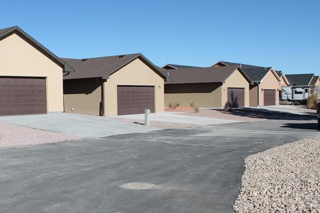151 S Stardust Cir, Pueblo West, CO 81007 - view of front facade with driveway, stucco siding, and a residential view