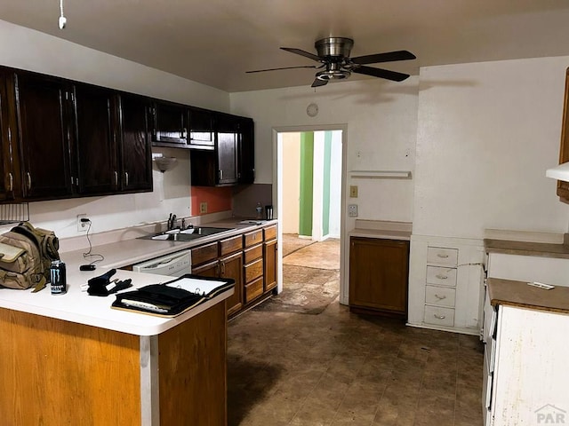 kitchen with a peninsula, a sink, a ceiling fan, light countertops, and dishwasher