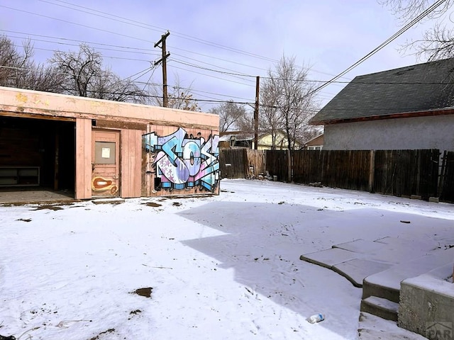 yard layered in snow with fence