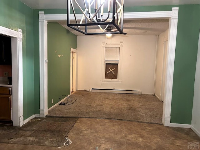 unfurnished dining area with carpet floors, an inviting chandelier, baseboards, and baseboard heating