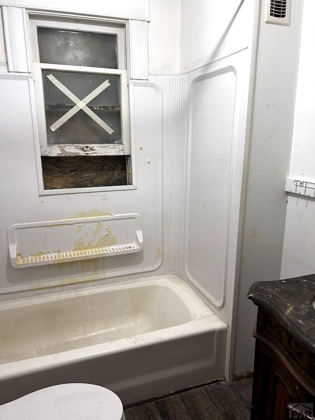 full bath featuring visible vents, shower / tub combination, wood finished floors, and vanity