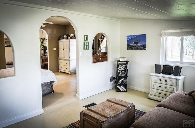 8570 Pine Dr, Beulah, CO 81023 - living area featuring arched walkways and wood finished floors