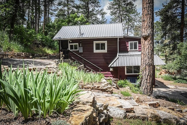 8570 Pine Dr, Beulah, CO 81023 - rear view of property featuring a metal roof and stairs