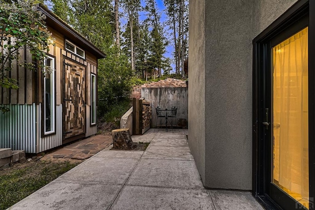 exterior space with fence, a patio, and stucco siding