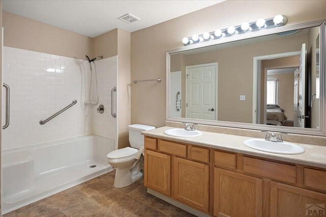 4317 Outlook Blvd Unit D, Pueblo, CO 81008 - ensuite bathroom featuring double vanity, a shower, and toilet