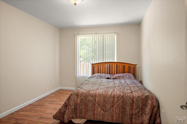 4317 Outlook Blvd Unit D, Pueblo, CO 81008 - bedroom featuring wood finished floors and baseboards