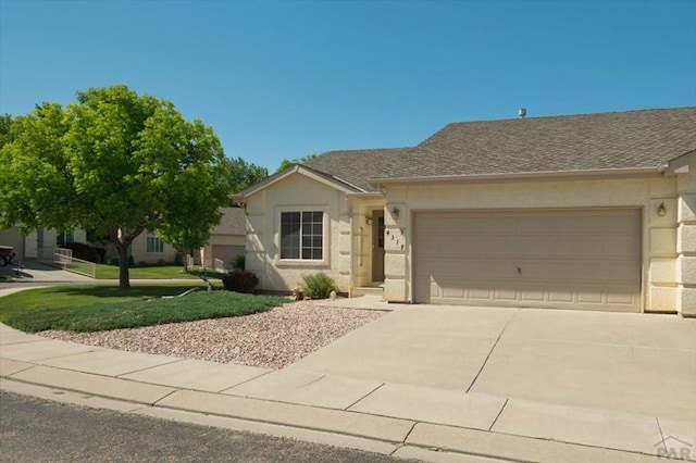 4317 Outlook Blvd Unit D, Pueblo, CO 81008 - ranch-style home with concrete driveway, a garage, a front lawn, and roof with shingles