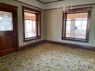 entrance foyer with carpet flooring and baseboards