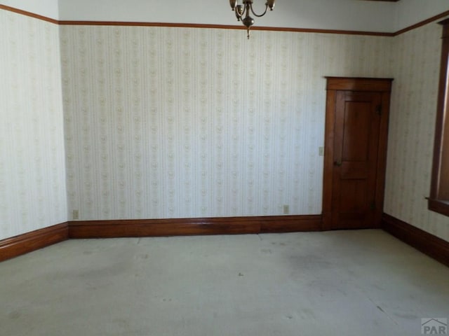 carpeted spare room featuring baseboards and wallpapered walls