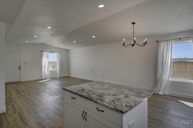 1436 Brewery Rd, Pueblo, CO 81001 - kitchen with white cabinets, vaulted ceiling, wood finished floors, and a chandelier