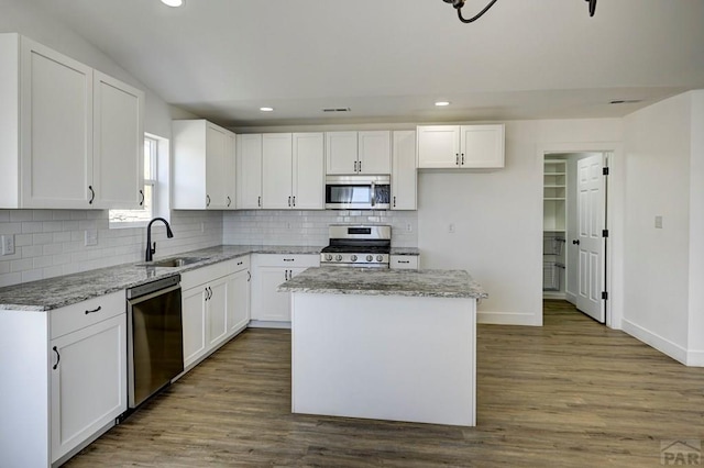 1436 Brewery Rd, Pueblo, CO 81001 - kitchen featuring backsplash, light stone countertops, stainless steel appliances, and a sink